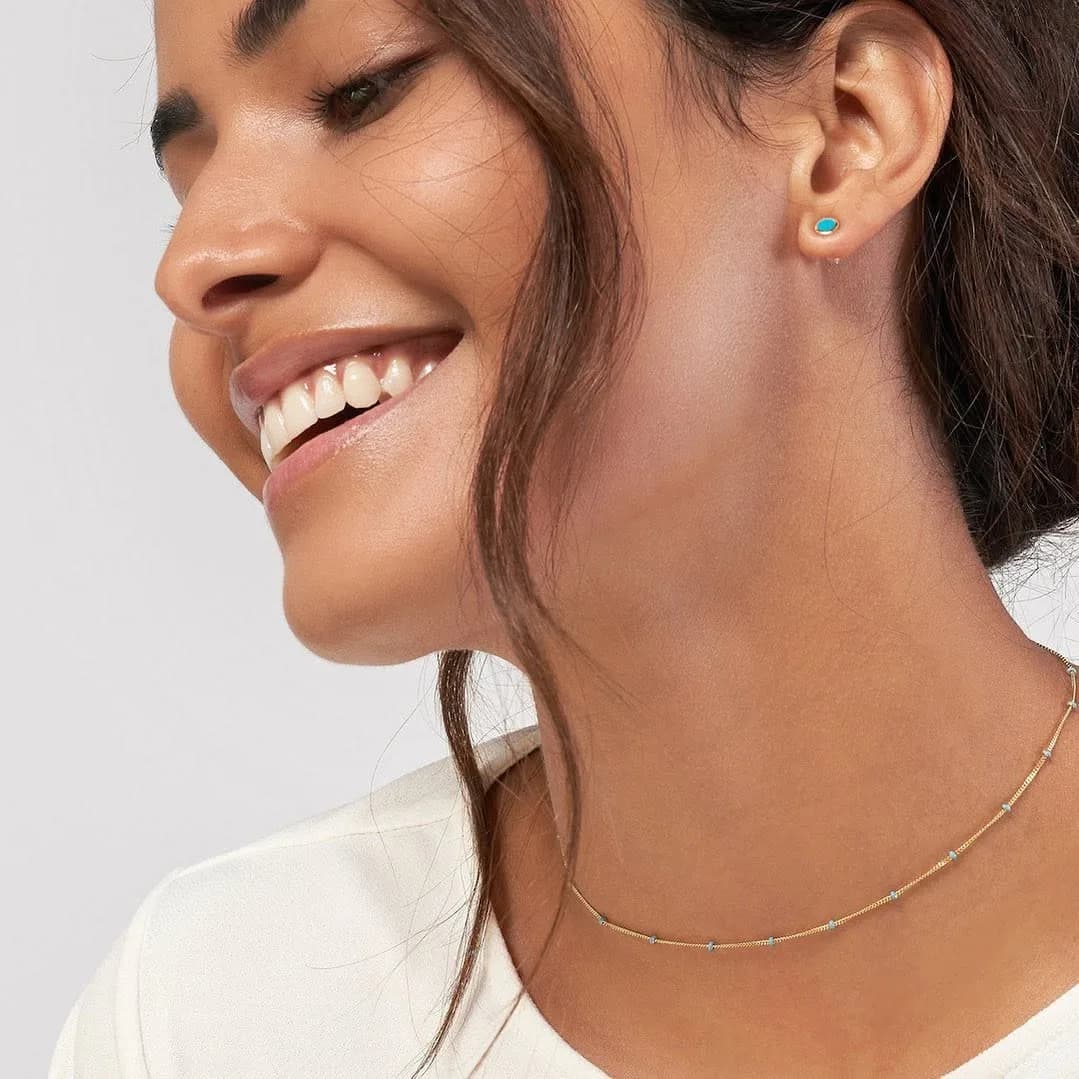 Model wearing a WJD Exclusives gold and turquoise necklace